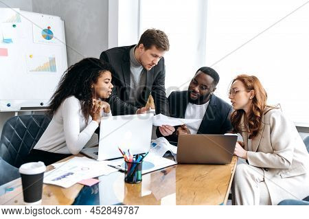 Multiracial Business Team On Briefing, Discussing Ideas For New Startup Or Project. Serious Stylish 