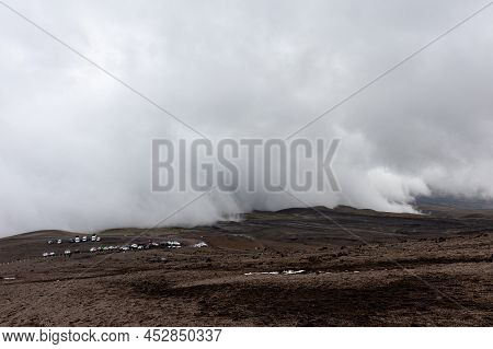 View At Parking Place Under Huge Clouds On Cotopaxi Volcano. Ecuador, Cotopaxi National Park