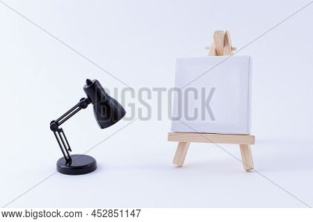 Wooden Easel Miniature With Blank White Square Canvas For Artists And Painters - Mockup. Mini Wooden