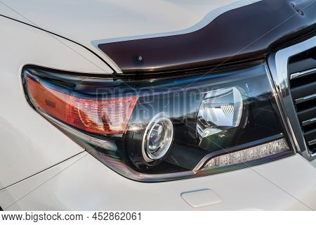 Novosibirsk, Russia - 04. 12. 2022: Front Headlight View Of Toyota Land Cruiser 200 J200 2013 Year W
