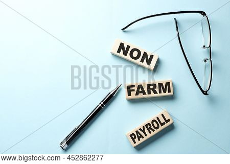 Non Farm Payroll Text On A Wooden Block ,blue Background