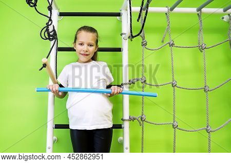 The Girl Smiles, Plays And Goes In For Sports On The Stairs And The Swedish Wall In The Children's C