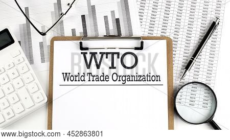 Paper With Wto - World Trade Organization Table On A Charts, Business Concept