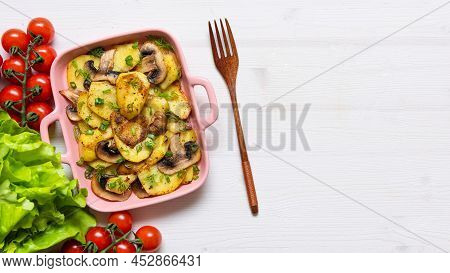 Bacon Tartiflette On A Baking Dish With Herbs And Vegetables At Home On A Wooden White Background. V
