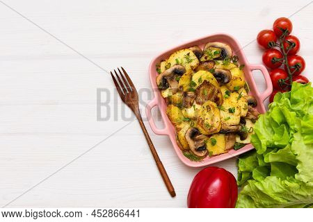 Baked Gratin Dauphine At Home On A Wooden Table With Cherry Tomatoes.