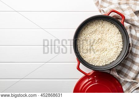 Uncooked Carnaroli risotto rice in a pot. Top view.