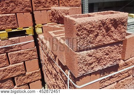 Hollow Red Spliter Blocks Bricks Stacked On Pallets For Sale.