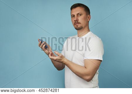 Man Checking Blood Sugar Level With Glucometer.