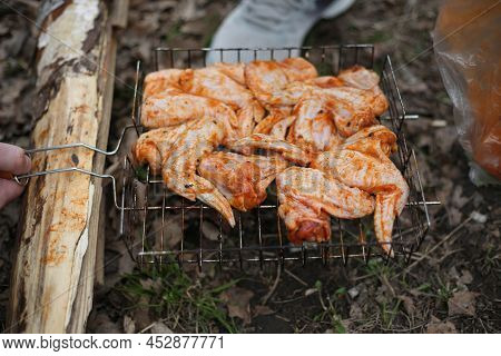 Metal Grill For Barbecue. Shish Kebab In Marinade Is Cooked On The Grill. Fried Chicken Meat With Sp