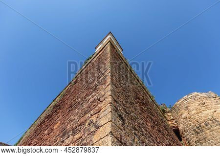 One Of Three Corners Of Triangular Fortress Chateau De Castelnau-bretenoux And Round Tower Against A