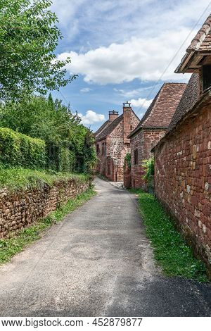 Street With Perfectly Preserved Medieval Residential Masonry Buildings On Outskirts Of Collonges-la-