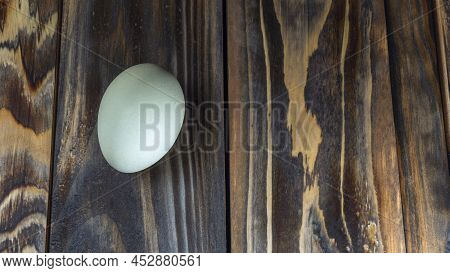 Araucana Egg On Wooden Background. Light Blue Egg From Araucana Chicken. Easter Festival Concepts. E