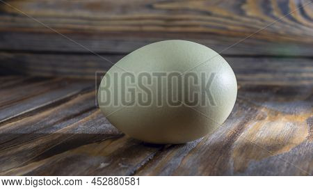 Araucana Egg On Wooden Background. Light Blue Egg From Araucana Chicken. Easter Festival Concepts. E