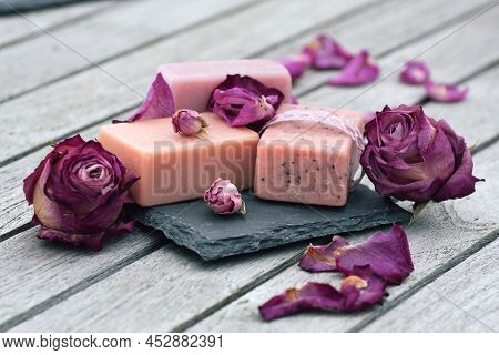Dried Purple Roses And Handmade Fragrance Soap On Gray Wooden Planks. Mother's Day Gift To Relax. Sh