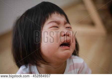 Image Of A Girl Crying At Home