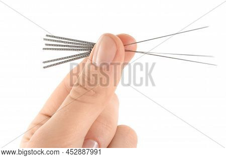 Woman Holding Needles For Acupuncture On White Background, Closeup