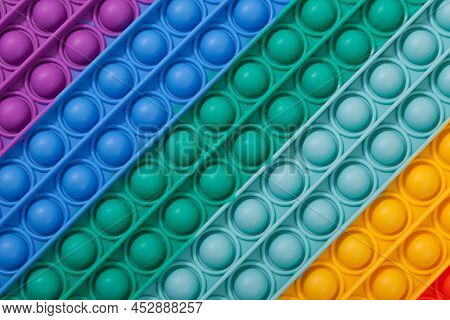 Surface Of Multi-colored Rubber Children's Toy Pop It, Close-up. Tap On Bubble, Finger Game.