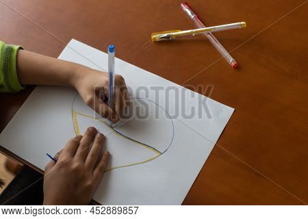 Childrens Hand With Pencil Draws The Heartl