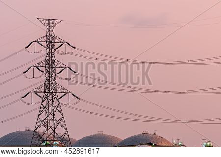 High Voltage Power Station. High Voltage Electric Tower On Sunset Background. Electrical Power Lines