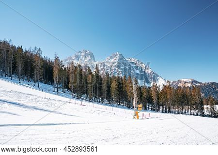 Scenic View Of Ski Tracks Against Trees On Snow Covered Majestic Mountains