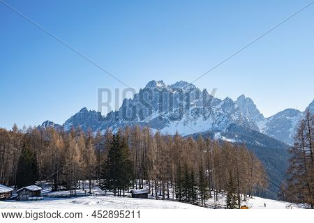 Scenic View Of Snow Covered House By Trees On Mountain Against Sky During Winter