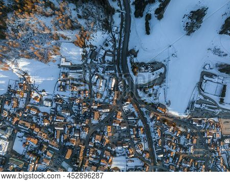 Aerial View Of Roads And Townscape On Snowy Landscape During Winter