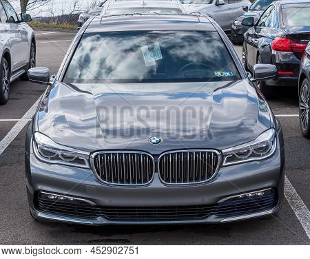 Monroeville, Pennsylvania, Usa April 10, 2022 A Bmw Sedan At A Dealership With The Sky Reflecting Of
