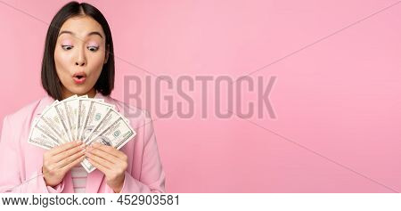 Finance, Microcredit And People Concept. Happy Smiling Asian Businesswoman Showing Dollars Money, St