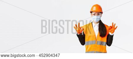 Covid-19 Safety Protocol At Enterpise, Construction And Preventing Virus Concept. Satisfied Asian Fe