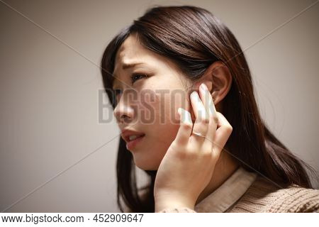A Woman Who Feels Uncomfortable In Her Ears