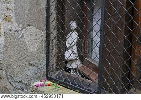 Rupit, Spain - September 09, 2014: Girl Statue Looking Through Window Guard In Rupit
