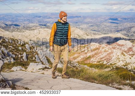 Man Traveller In Mountain Landscape At National Park Lovcen, Montenegro. Travel To Montenegro Concep