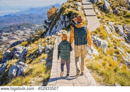 Dad And Son Travellers In Mountain Landscape At National Park Lovcen, Montenegro. Travel To Monteneg