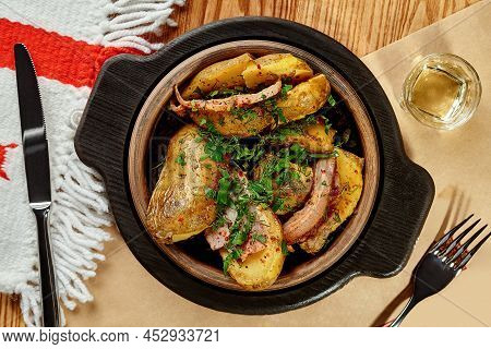 Baked Potatoes With Bacon Slices And Greens Served In Georgian Restaurant In Traditional Clay Ketsi 