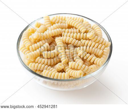 Uncooked Fusilli Corti Bucati Pasta In Glass Bowl Isolated On White Background With Clipping Path