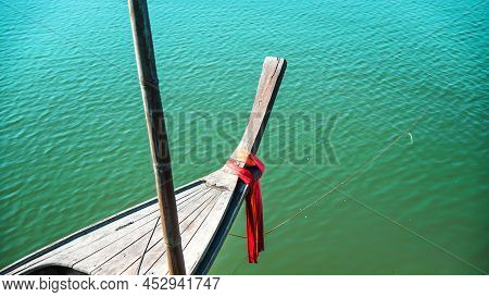 Photos Of The Bow Ship Head With Red Cloth Tied. View From Head Of Traditional Wooden Boat With Red 