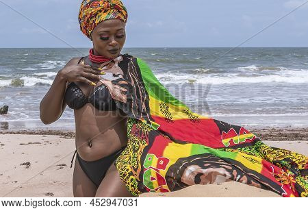 Dancing Ghana Woman On The Beautiful Beach Of Axim, Located In Ghana West Africa. Headdress In Tradi