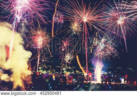 Background Festive New Year With Fireworks And Bokeh. New Year Fireworks On The Beach.