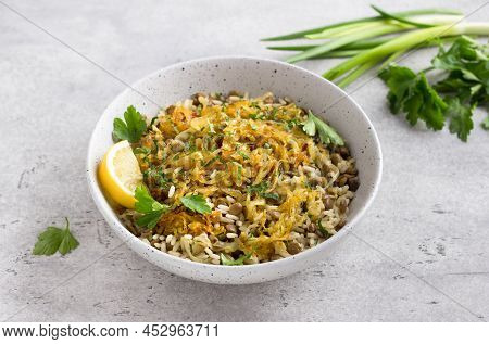 Traditional Middle Eastern Dish, Mujadara Of Lentils, Rice And Fried Onions With Lemon And Herbs On 