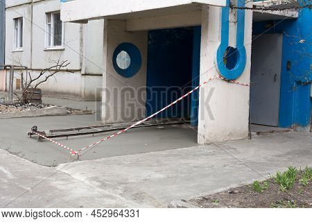New Concrete Blind Area Apartment Building. Blind Area Fenced With Red-white Barrier Tape. Process O