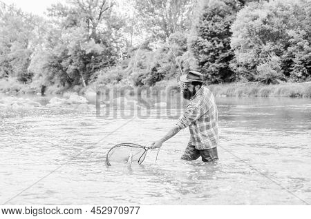 Reel Sport Fishing. Mature Man Fly Fishing. Man Catching Fish. Hobby And Sport Activity. Pothunter. 