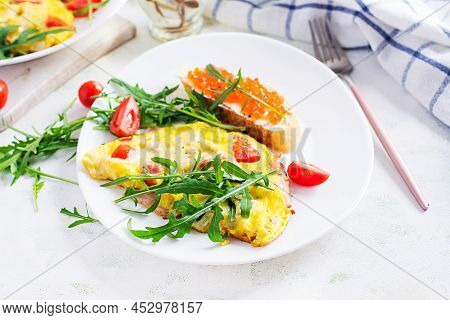 Omelette With Tomatoes, Cheese, Ham And Sandwich Wich Red Cavier On Plate. Frittata - Italian Omelet