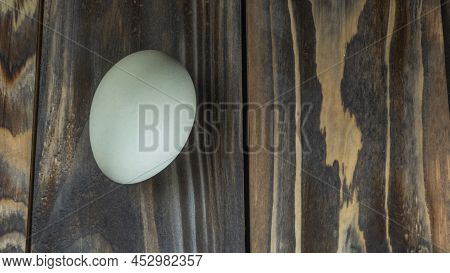 Araucana Egg On Wooden Background. Light Blue Egg From Araucana Chicken. Easter Festival Concepts. E