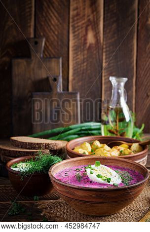 Cold Borscht, Summer Beet Soup With Fresh Cucumber, Boiled Egg And Baked Potatoes On Wooden Table. T