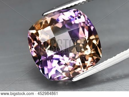 Natural Gemstone Colored Ametrine In Thongs On A Gray Background. Natural Bolivian Bicolor Yellow Pu