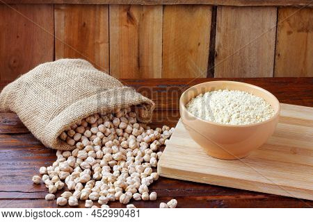 Organic Chickpea Flour In Bowl Over Rustic Wooden Table. Gluten Free