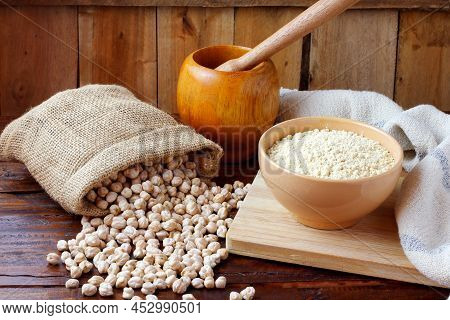 Organic Chickpea Flour In Bowl Over Rustic Wooden Table. Gluten Free