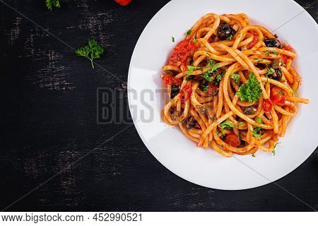 Spaghetti Alla Puttanesca - Italian Pasta Dish With Tomatoes, Black Olives, Capers, Anchovies And Pa