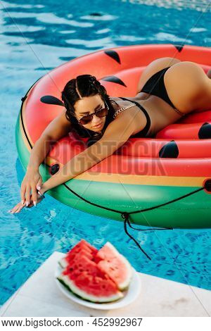 Sexy Woman Relax In Swimming Pool On Inflatable Pool Toy Watermelon Outdoors