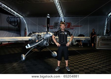 PUTRAJAYA, MALAYSIA - MAY 17, 2014: World champion Hannes Arch from Austria poses with his Edge 540 v3 plane in his hangar at the Red Bull Air Race World Championship 2014 in Putrajaya, Malaysia.